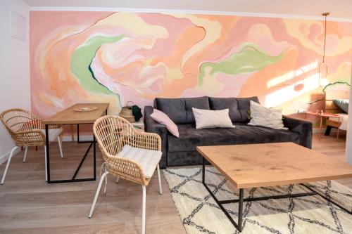 a living room with a couch and two tables at Hostel Havana in Banja Luka