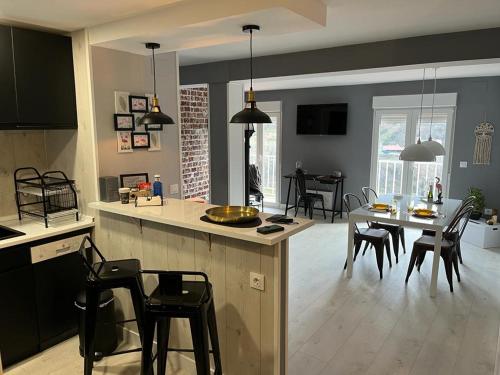 a kitchen and living room with a table and chairs at El Rinconcito de Bejar in Béjar