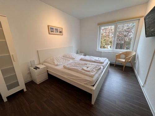 1 dormitorio con cama y ventana en Leuchtfeuer Fewo "Andersen", en Börgerende-Rethwisch