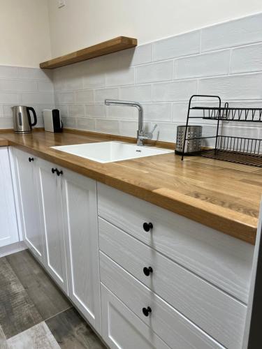 a kitchen with a sink and a wooden counter top at Ramallah Modern Apartments - 2 bedrooms in Al Bīrah