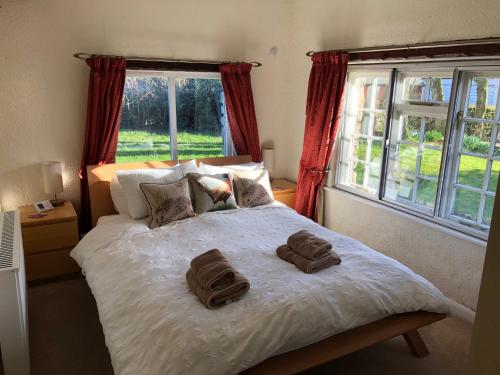 a bedroom with a bed with two towels on it at Locka Old Hall Cottage in Arkholme