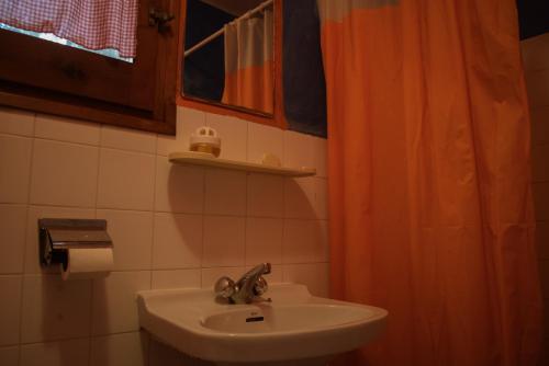 a bathroom with a sink and a shower curtain at La Casa de Las Burbujas Azules in Caspe