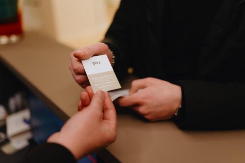 a person handing another person a piece of paper at NEW IPOINT HOTEL in San Giovanni in Persiceto