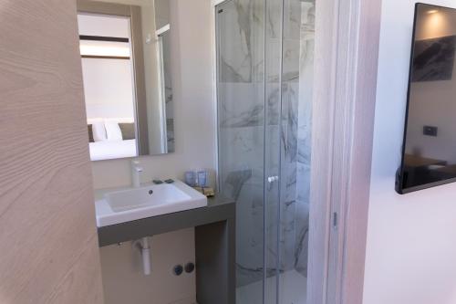 a bathroom with a sink and a shower at Pietra Bianca Hotel in Numana