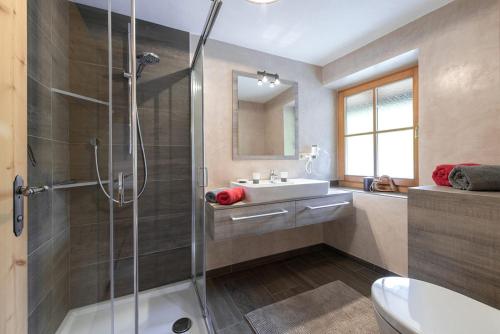 ein Bad mit einer Dusche und einem Waschbecken in der Unterkunft Oberglarzhof App Zirbel in Villnöß