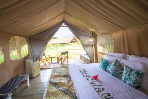 a bedroom with a bed in a tent at Wild Glamping Gal Oya - Thema Collection in Galgamuwa