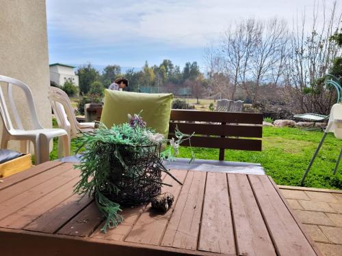 a wooden table with a pillow on a bench at Holiday home in Galilee in Sheʼar Yashuv