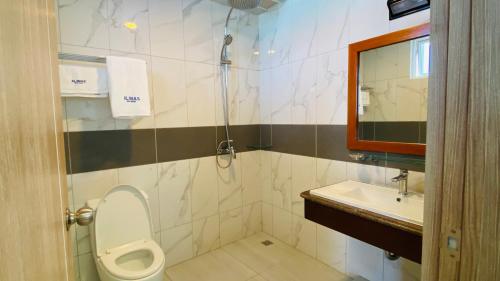 a bathroom with a toilet and a sink and a shower at Alimas Holiday Retreat Maldives in Felidhoo