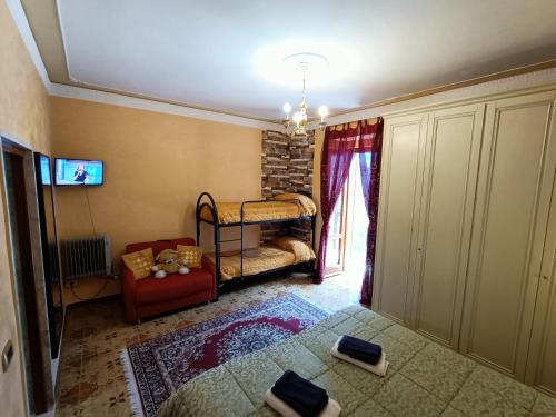 a living room with a bed and a red chair at Casa Belvedere - Centro Storico in Barletta