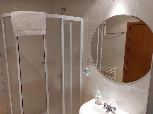 a bathroom with a sink and a mirror and a shower at Studio Villa Park 410 in Borovets