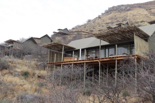 a house on a hill with a mountain at TimBila Safari Lodge in Omaruru