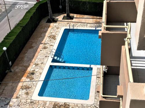 een uitzicht over een zwembad met blauw water bij Apartamento Riviera con vistas al mar REF 024 in Benicàssim