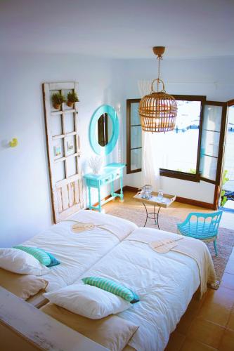 a bedroom with a large bed and a chandelier at Casa Eneida frente al mar in Tías