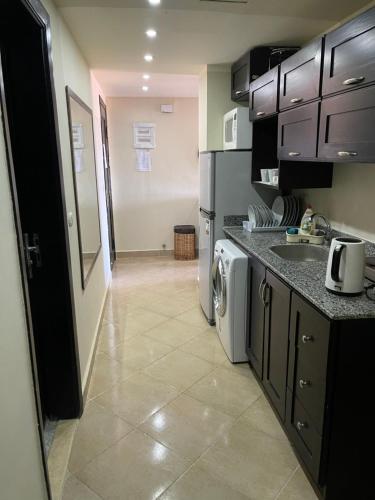 a kitchen with a washer and dryer in at sea view apartment in Porto Marina hotel tower in El Alamein