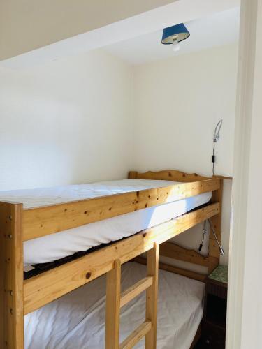 Ce lit superposé se trouve dans une petite chambre. dans l'établissement BEAUMER - Men Dû, Parking, Wifi - UD96, à Carnac