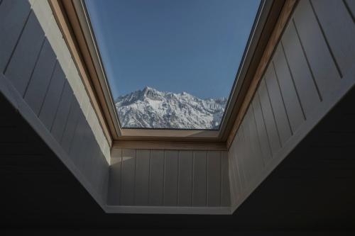a window in a room with a view of a mountain at Hotel Garnì Cristallo in Ponte di Legno