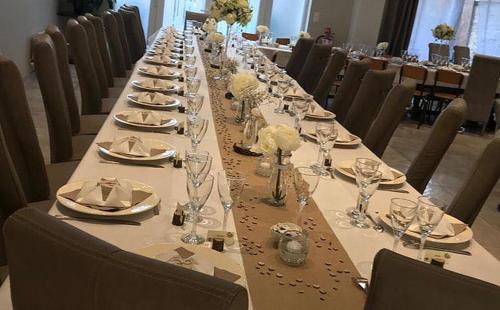 a long table with plates and glasses on it at Bienvenue A La Campagne in Villers-sur-Port