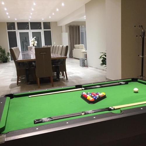 a room with a pool table and a dining room at Bienvenue A La Campagne in Villers-sur-Port