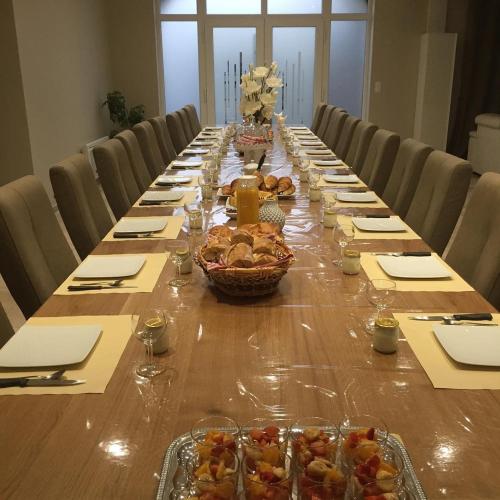 a long long table with bowls of food on it at Bienvenue A La Campagne in Villers-sur-Port