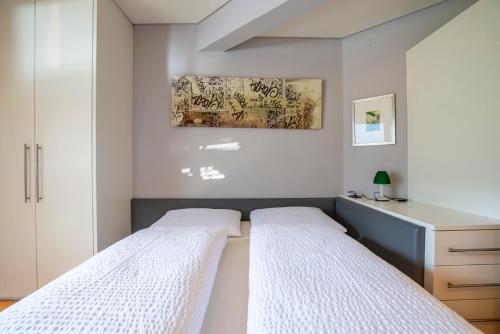 two beds in a bedroom with white walls at Tubris Living in Sand in Taufers