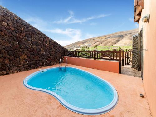 a hot tub on the patio of a house at Belvilla by OYO Holiday home in Jand a in Morro del Jable