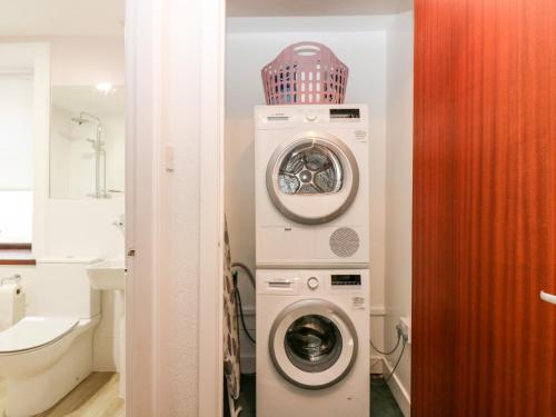 a laundry room with a washer and dryer in it at 4 Gordon Street in Buckie
