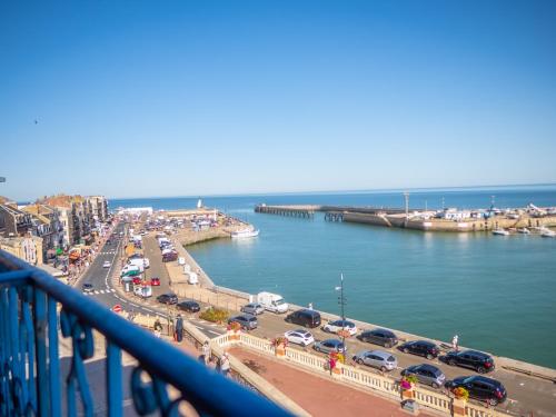 a view of a city with cars parked on a bridge at Hôtel De Calais in Le Tréport