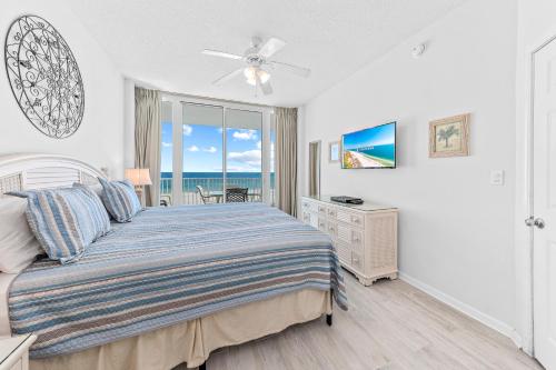 a bedroom with a bed and a view of the ocean at Lighthouse 307 in Gulf Shores