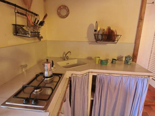 a kitchen with a stove and a sink at Farmhouse in Umbertide with Pool in Umbertide
