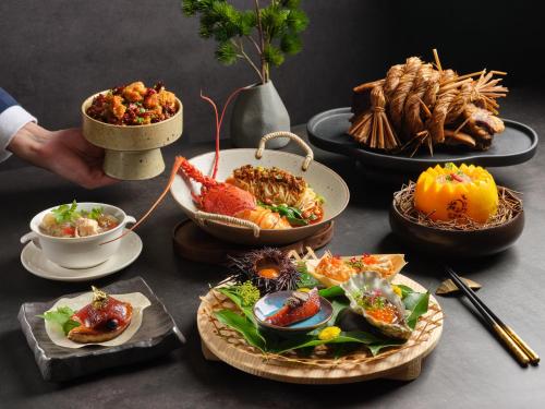 a table topped with different types of food on plates at InterContinental Singapore by IHG in Singapore