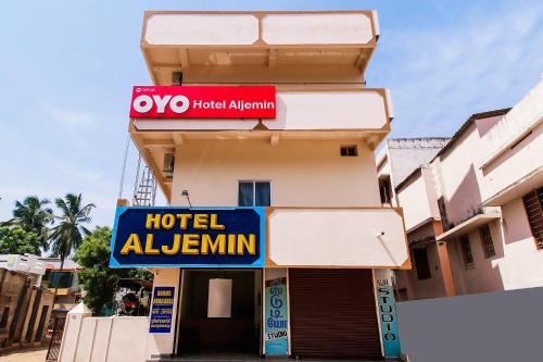 a hotelulum sign on the side of a building at Hotel Aljemin in Kanyakumari