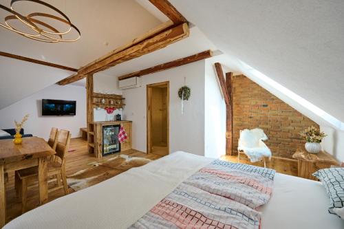 a bedroom with a bed and a table and a brick wall at Tourist Farm Firbas in Cerkvenjak