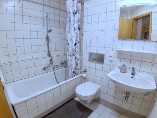 een witte badkamer met een toilet en een wastafel bij LEA-Apartment, 2 Raum, Balkon TG zentral am Park in Leipzig