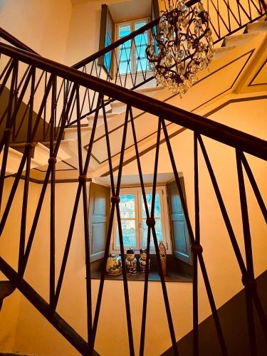 a spiral staircase with a chandelier in a room at Hotel Casa Camilla in Verbania
