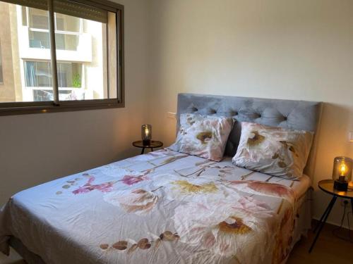 a bedroom with a bed with flowers on it at La Perla de Marrakech Appart de Luxe in Marrakesh