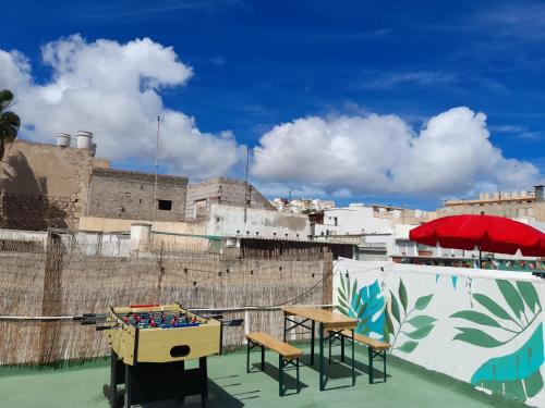 a patio area with chairs, tables and umbrellas at Stardust House Vegueta in Las Palmas de Gran Canaria