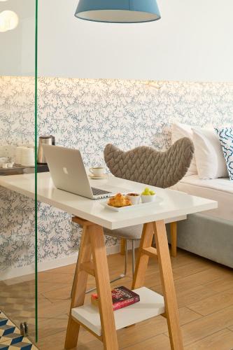 a table with a laptop on it in a living room at TUI BLUE Makarska - Adults Only in Igrane