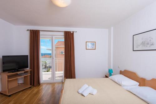 Posteľ alebo postele v izbe v ubytovaní Apartments Darjan