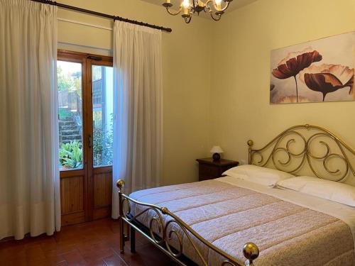 a bedroom with a bed and a large window at La Sosta in Panzano
