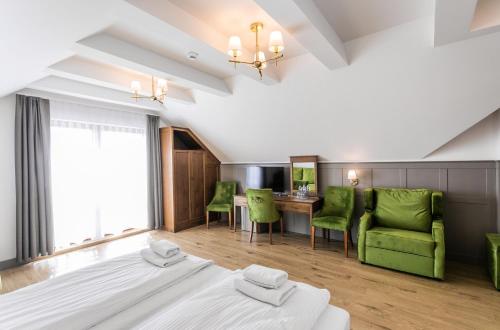 a bedroom with a bed and a table and chairs at Nordowi Dwór in Celbowo