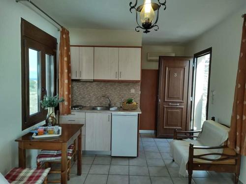 a kitchen with a table and a dining room at AEOLUS Studios in Xerokampos