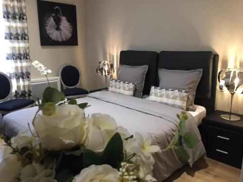 a bedroom with a large bed with white flowers on it at Bienvenue A La Campagne in Villers-sur-Port