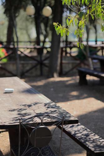 a wooden picnic table sitting next to a bench at Agriturismo Villa Guarnaschelli in Scandicci