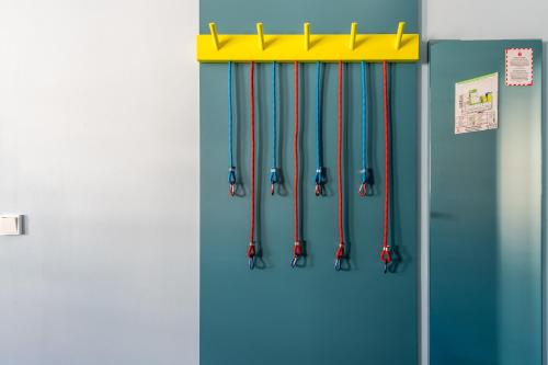 a refrigerator with a bunch of cords hanging from it at MEININGER Hotel Innsbruck Zentrum in Innsbruck