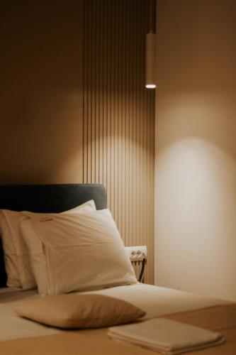 a bedroom with a bed with a white pillow at Sharm Hotel Luxury in Gjirokastër
