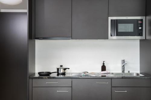 a kitchen with a sink and a microwave at Townhouse N26 in St. Moritz