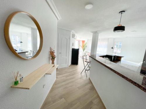 una cucina con bancone e specchio sul muro di Apartamento en 1ª línea con piscina ad Alicante