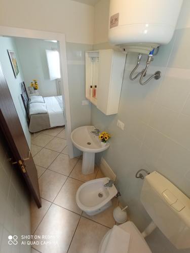 a small bathroom with a toilet and a sink at Residence Poseidon in Lido Marini