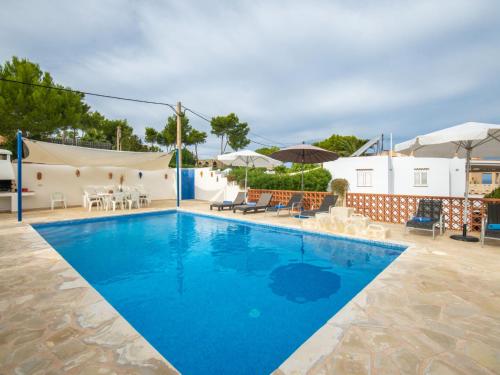 a large swimming pool with blue water at Holiday Home Anromi by Interhome in Cala Vadella