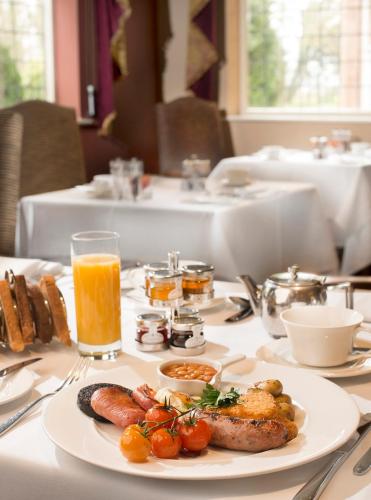a table with a plate of food on a table at Hatherley Manor Hotel & Spa in Gloucester